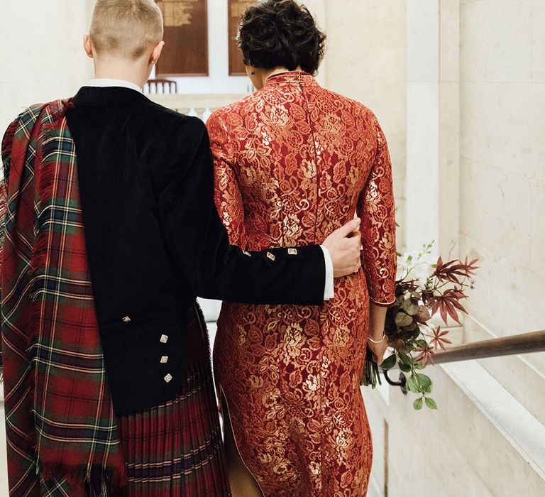 Bride and groom in traditional outfits for city wedding