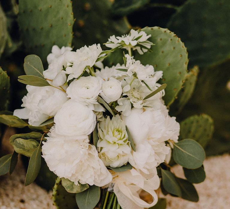 White floral bouquet complete with green foliage