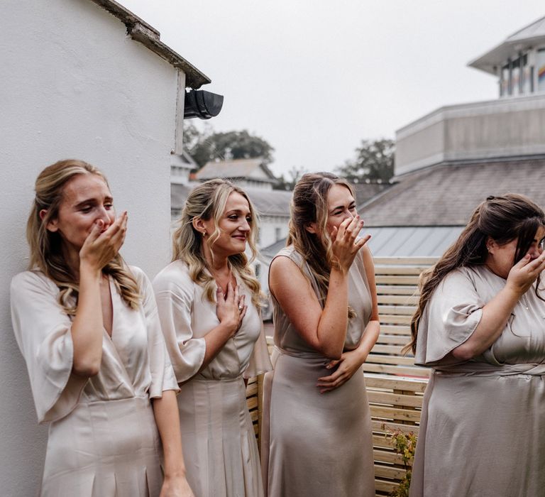 Bridesmaids get emotional as they see bride in her dress