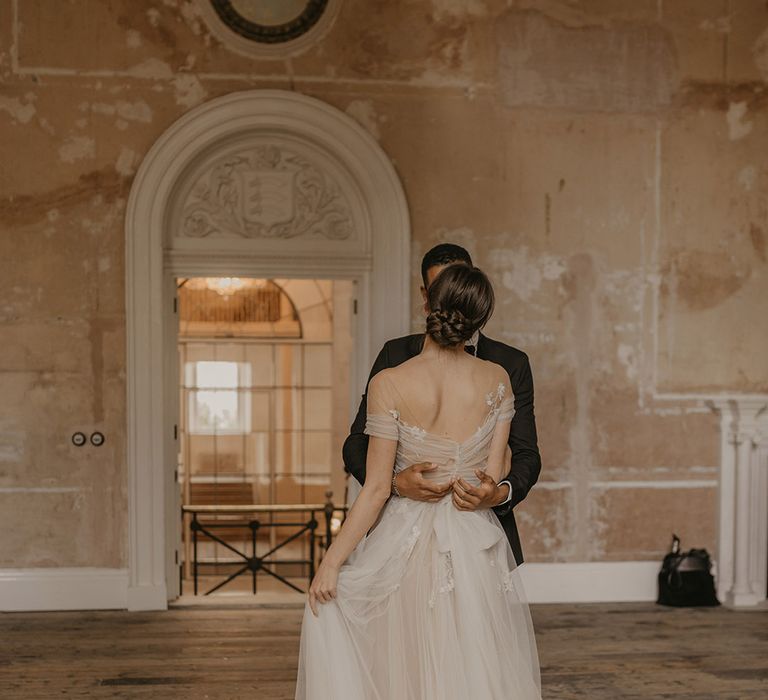 Bride and groom first dance in a reception room at Clerkenwell House with high ceilings and distressed walls