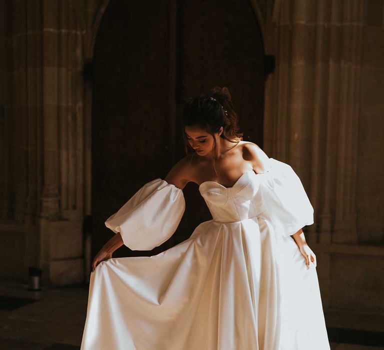 Bride in a Nortier Shallow wedding dress with strapless bodice, detachable sleeves and full skirt 