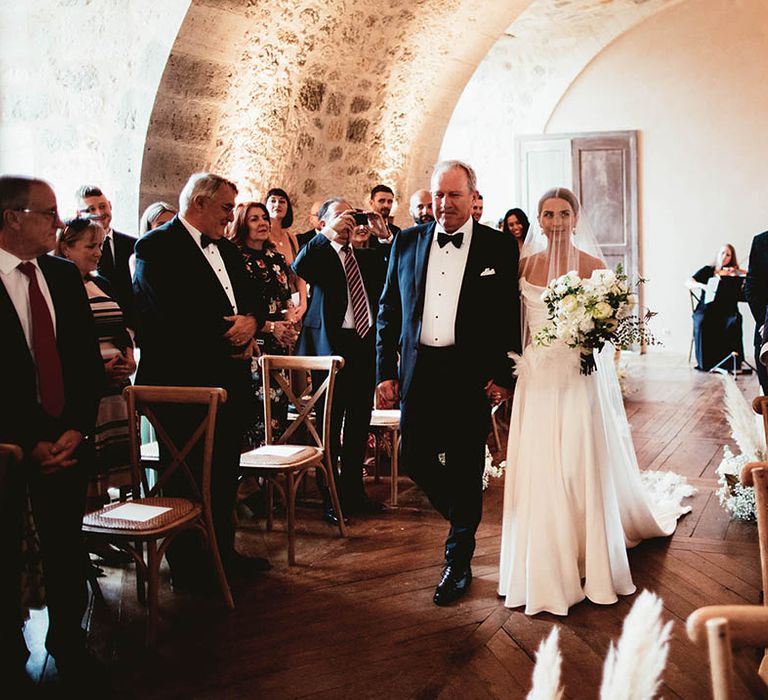 Bride walks down the aisle on her wedding day