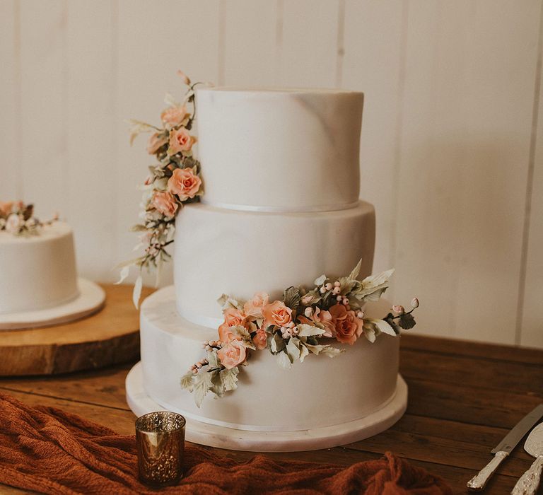 Marble wedding cake with peach flower decor