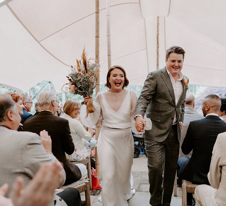 Bride and groom descending up the aisle after their bespoke wedding ceremony at The Copse Country House 