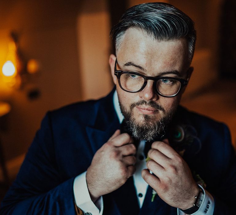 Groom in blue velvet suit jacket with glasses and personalised shirt