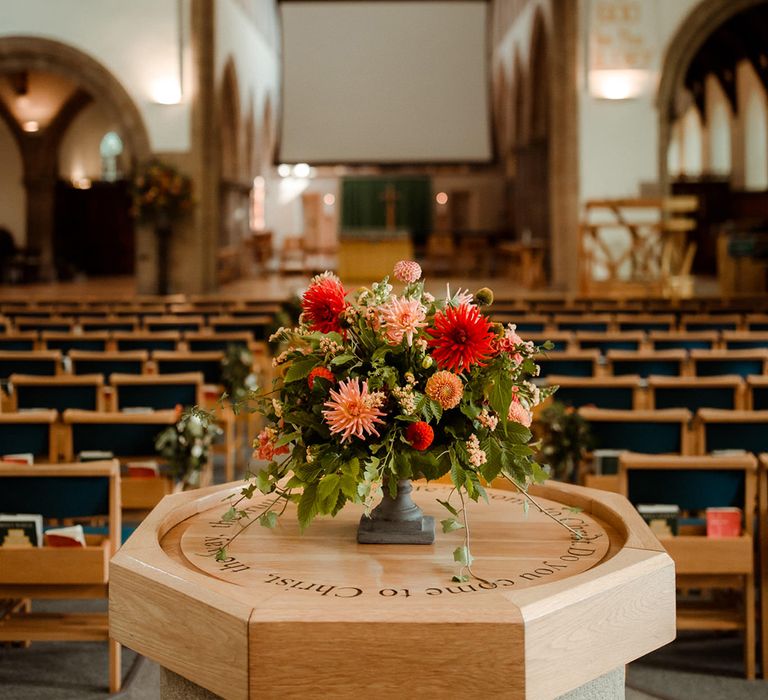 Peachy pink and red wedding flowers for church wedding ceremony in North East England 