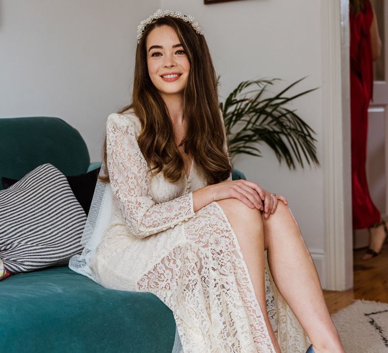 Bride sits ready in her Rixo dress for her wedding day with blue stiletto wedding shoes