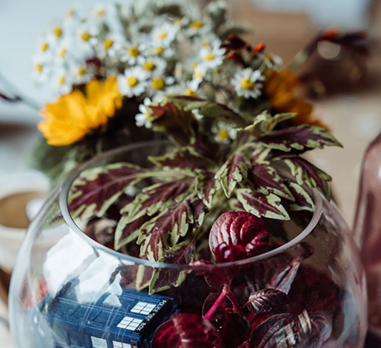 Terrarium table decor for wedding reception with Doctor Who paraphernalia for fandom theme wedding 