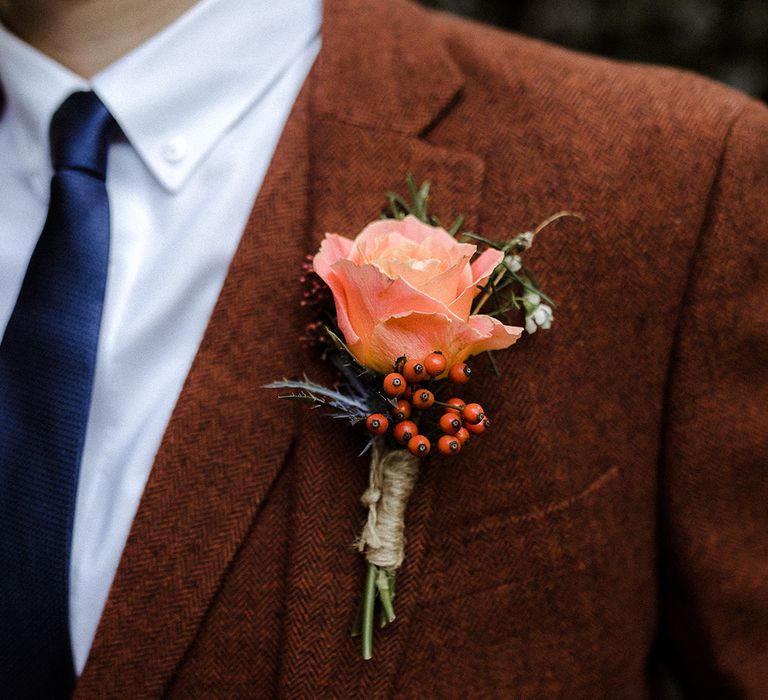 Pink rose and berry buttonhole on brown suit with blue tie for groom outfit 