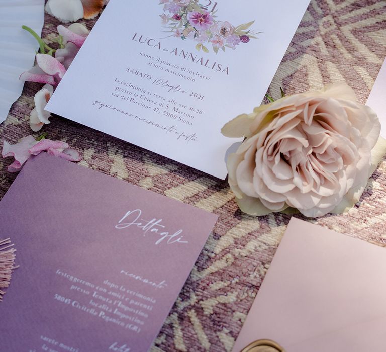 Lavender wedding stationery complete with floral illustration surrounded by florals 