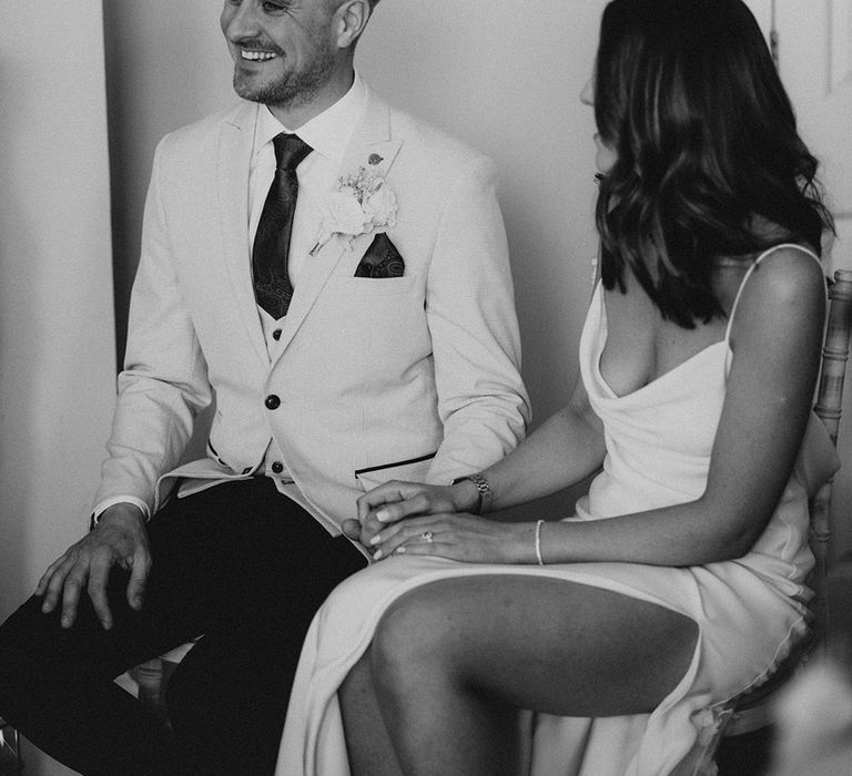 Bride and groom sit together for their intimate wedding ceremony 