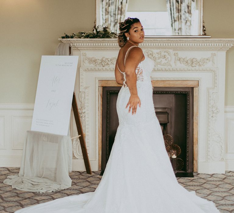 Bride in a glitzy wedding dress with a long train and illusion back wedding dress