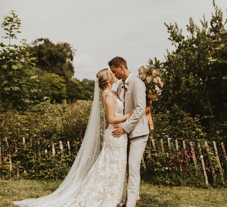 Bride and groom share a kiss on their wedding day at Nancarrow Farm 