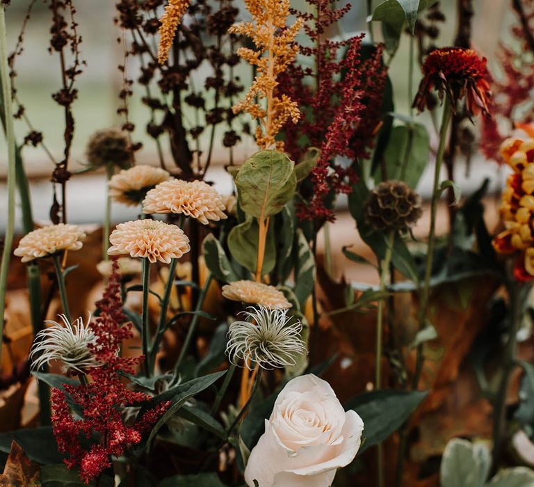 Orange, red and pale pink wedding flower decor for autumnal wedding 