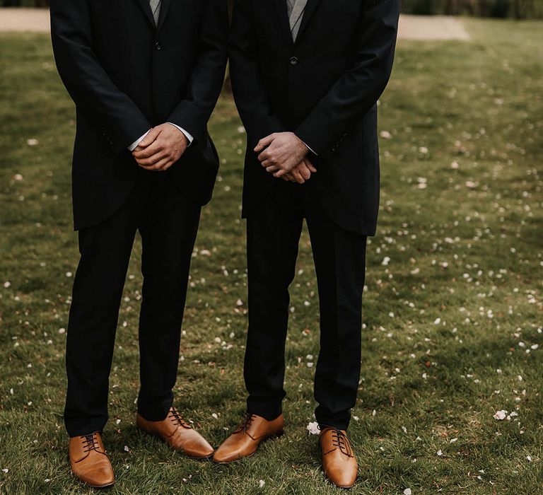 Groom and best man in morning suits, pink buttonholes and different ties and pocket squares 