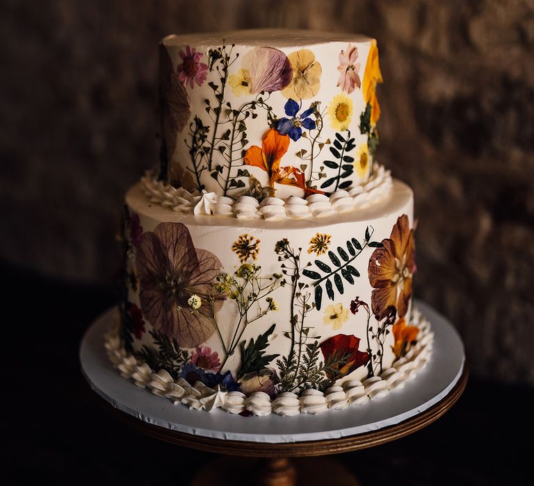 Two tier white iced pressed flower wedding cake 