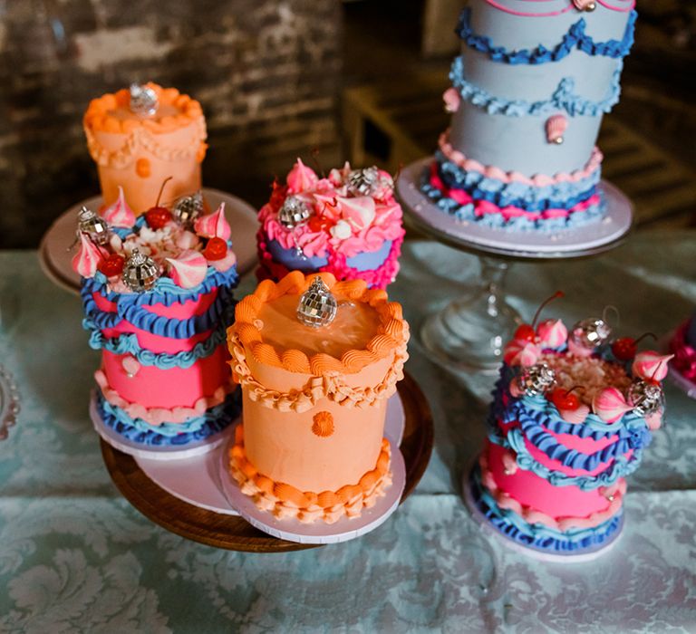 Retro styled mini wedding cakes complete with disco ball decor 