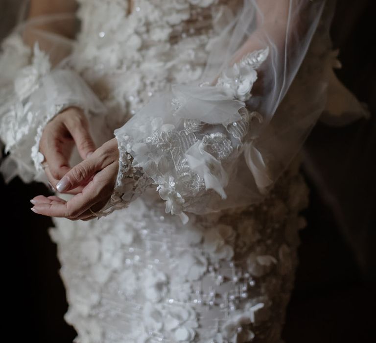 Bride wears floral appliqué Pronovias wedding dress with sheer removal sleeves 