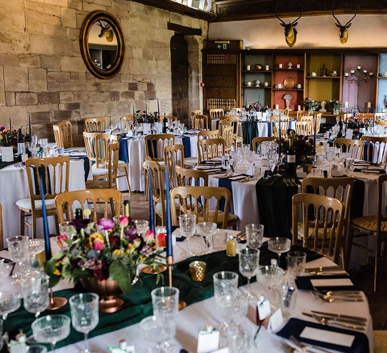 Brinsop Court Manor House and Barn wedding tablescape with blue, red, and green jewel tones 