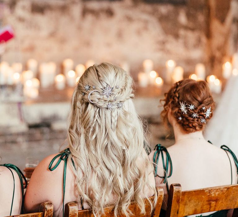 Bridesmaids in forest green satin bridesmaid dresses with tie straps and silver bejewelled celestial hair accessories at Asylum Chapel London 