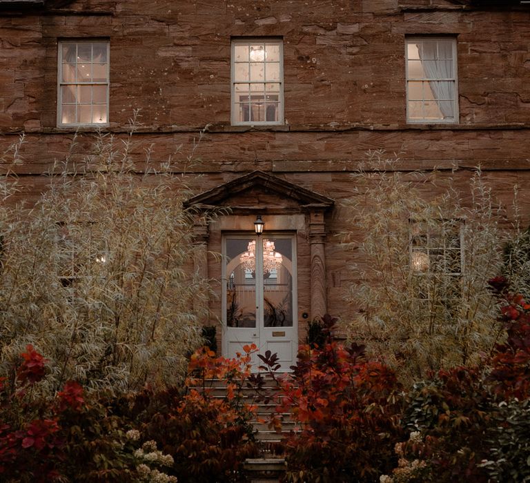 Newton Hall wedding venue in Northumberland lit up for the evening 