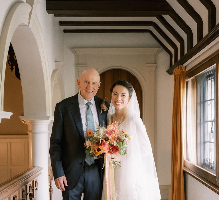 Father of the bride with the bride in a classic Andrea Hawkes bridal gown 