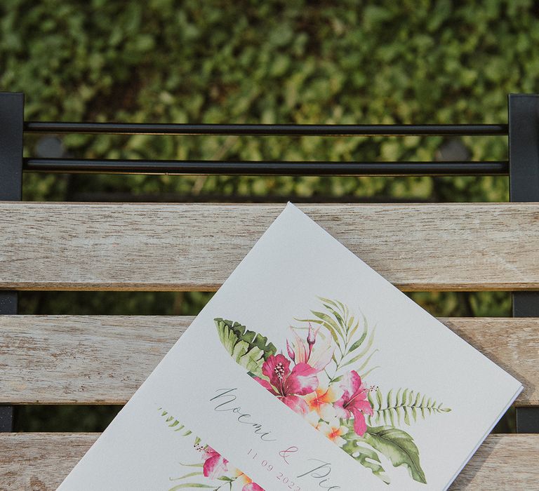 white wedding invitation with tropical pink flower and foliage design