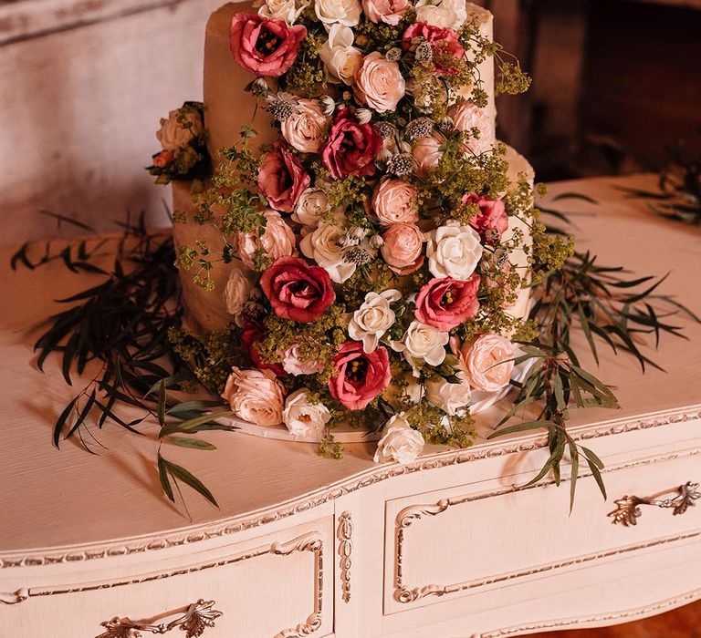 Light and dark pink epic floral design on three tier wedding cake 