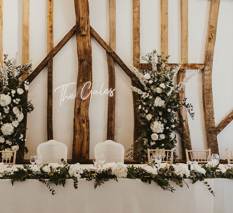 Villiers Barn wedding venue decorated with white wedding flowers and white neon wedding sign 