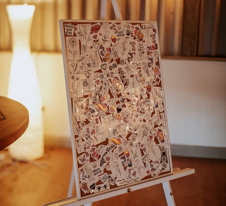 A giant board pegged with temporary tattoos for guests to use at the wedding 