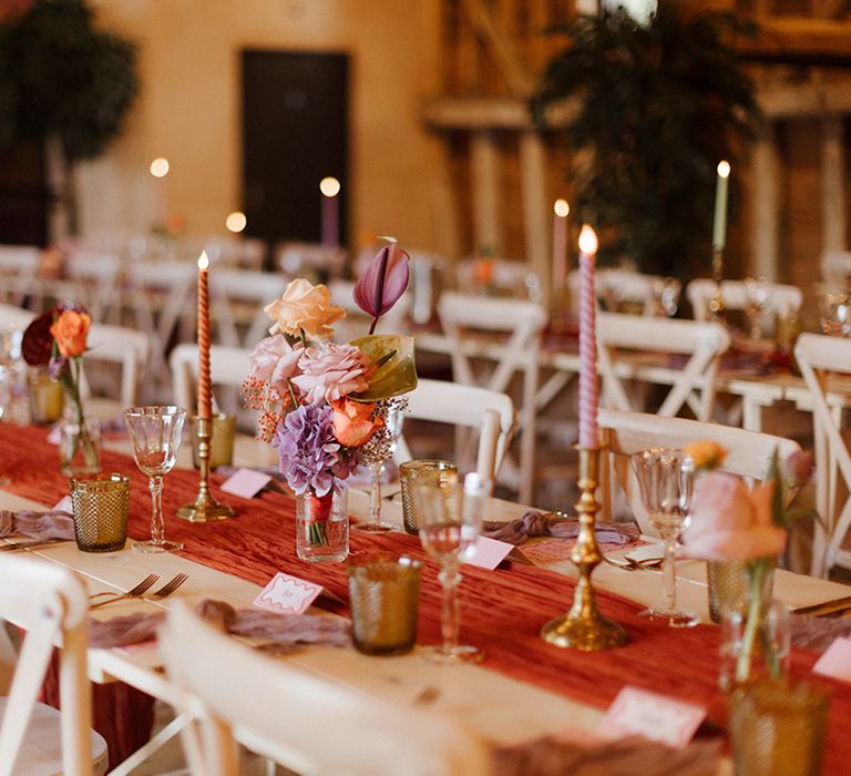 Wedding tablescape with pastel colours and deep orange wedding table runner 