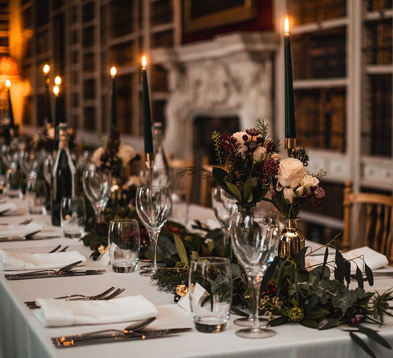 Cosy library at St Giles House with dark green and red colour palette for winter wedding 