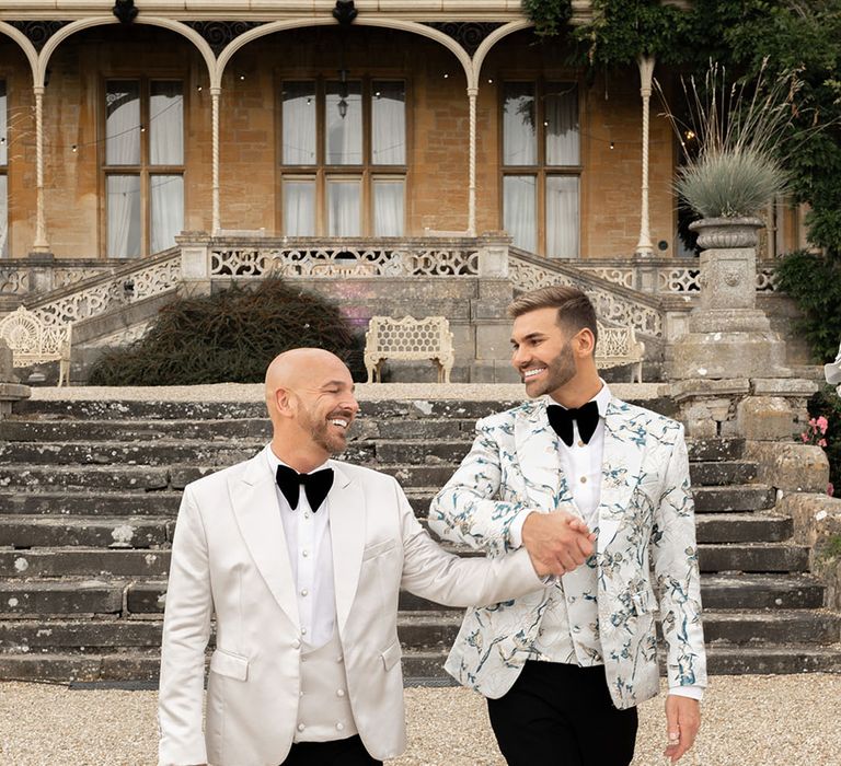 Two grooms in funky patterned suit jackets for gay wedding 