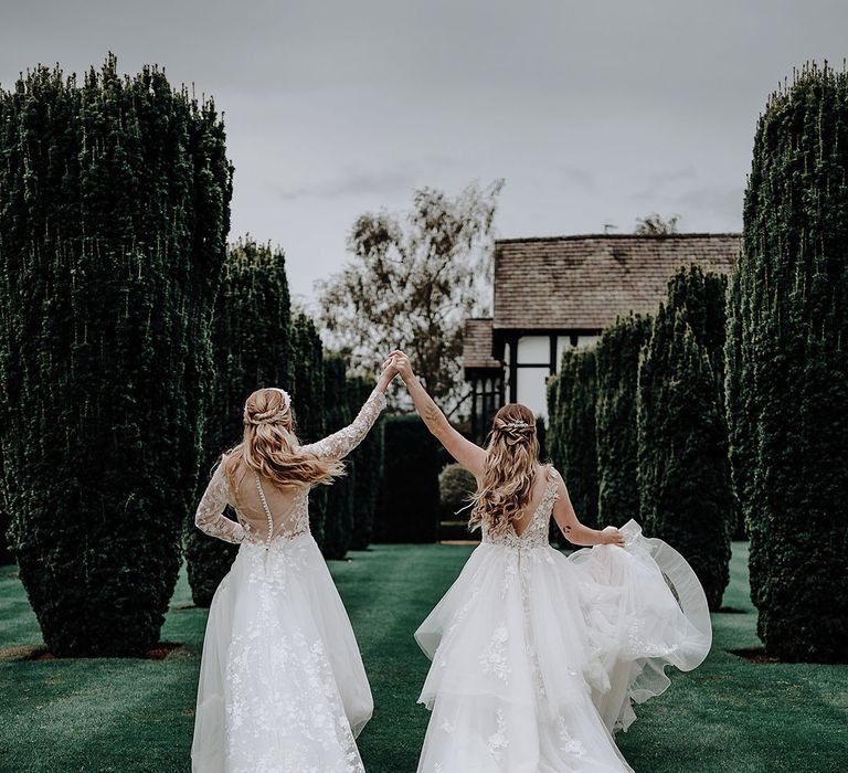 Two brides wearing princess wedding dresses at Cheshire wedding venue for their garden elopement 