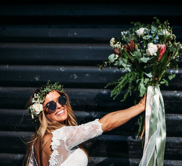 Bride wears sunglasses and floral crown with lace 1/4 sleeve bridal separate with full skirt by Joanna Bongard Photography