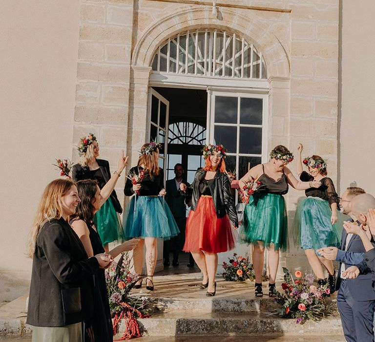 Bridal party wearing black leather jackets with tulle tutu bridesmaid dresses at colourful elopement wedding 