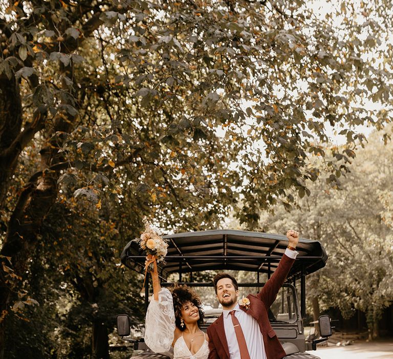 Bride and groom with the black safari jeep at Port Lympne hotel and reserve 