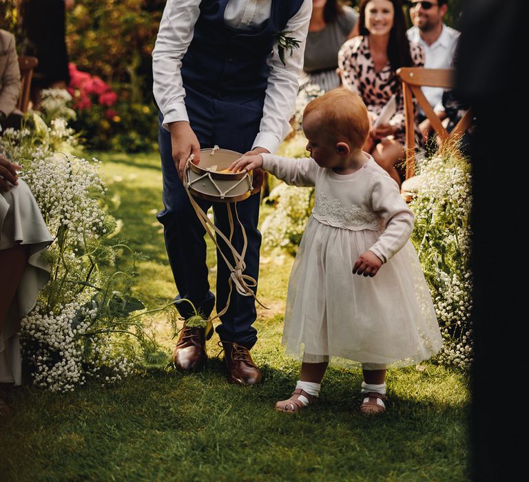 Page boy and flower girl walking down the aisle with petals 