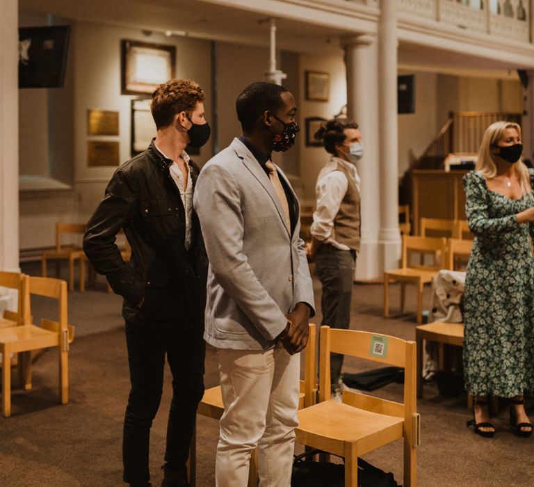 Socially distanced wedding guests at church micro wedding 