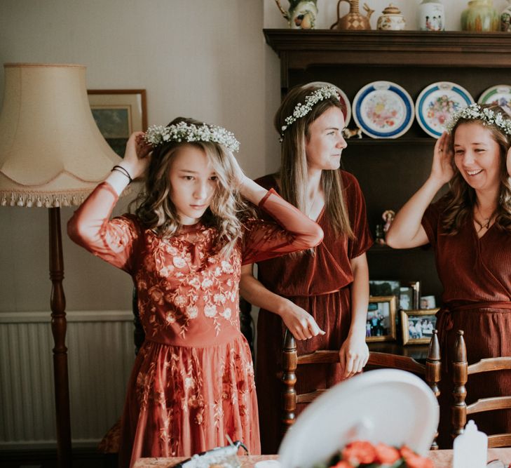 Bridesmaids in rust coloured dresses on the wedding morning 