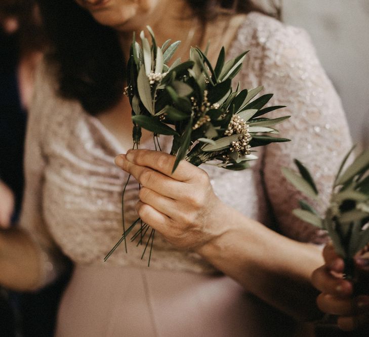 Guest holding Olive bouquet favours