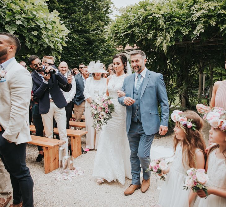 Bride walks down the aisle in Christina Wu bridal dress