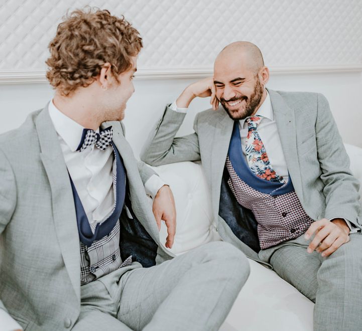 The grooms choose their tailored wedding suits together