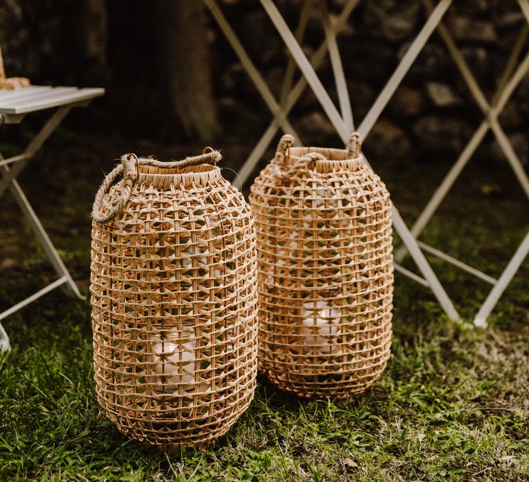 Wicker candle holders in outdoor reception setting