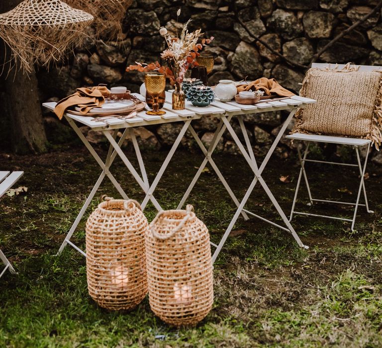 White wooden table complete with rustic table setting