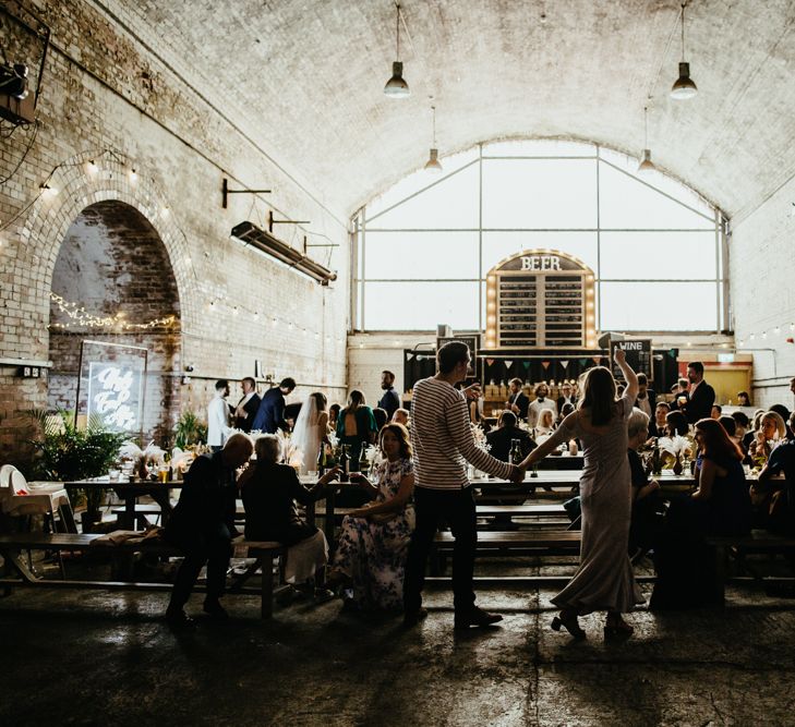 Couple enter bar at wedding