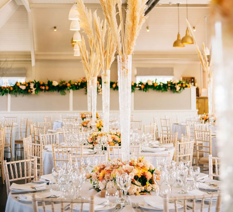 Peach and white wedding table décor with pampas grass and citrus centerpiece 