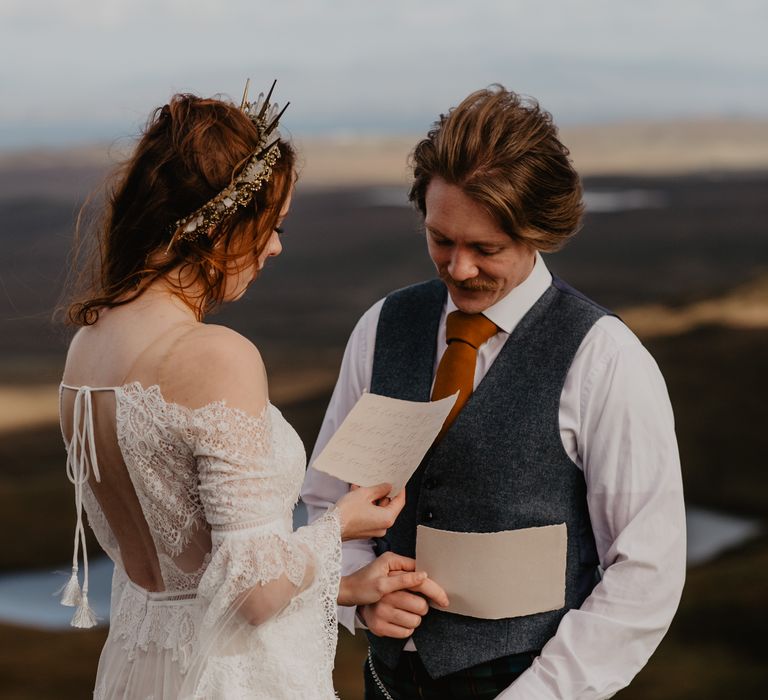 Bride & groom read vows to one another on the hillside