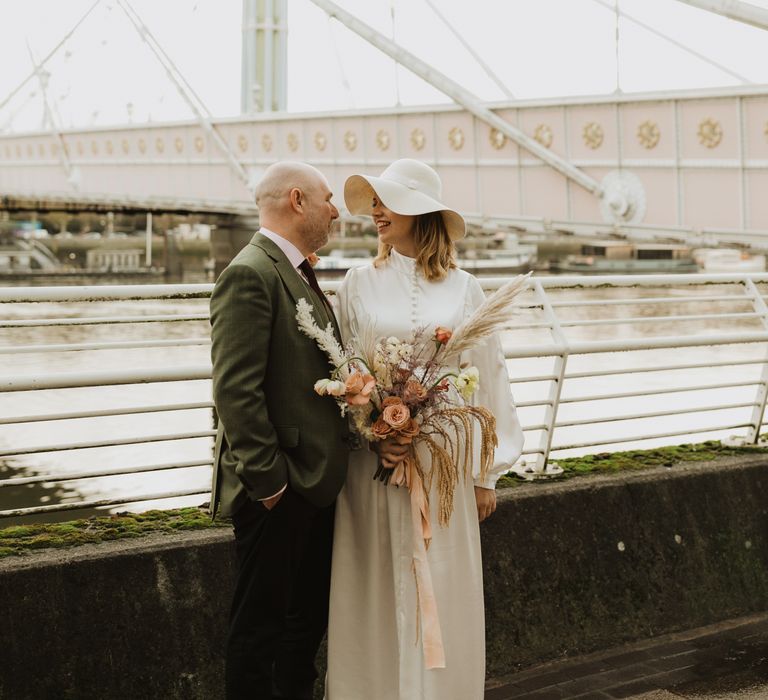 Bride & groom look lovingly at one another on the bride 