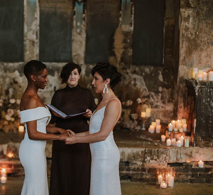 Two brides holding hands at their intimate humanist wedding ceremony at The Asylum Wedding Venue 